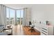 Bright room with hardwood floors, large windows, cityscape view, and white desk at 2870 Pharr Court S Nw # 1608, Atlanta, GA 30305