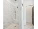 Tiled walk-in shower with rainfall shower head and built-in bench in this contemporary bathroom at 3130 Bennett Creek Ln, Suwanee, GA 30024