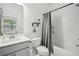 Clean bathroom with a sink, toilet, and shower featuring tiled walls and modern fixtures at 3130 Bennett Creek Ln, Suwanee, GA 30024