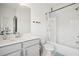 Modern bathroom with gray vanity, white countertop, large mirror, and shower-tub combo at 3130 Bennett Creek Ln, Suwanee, GA 30024