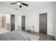 Bright bedroom features hardwood floors, ceiling fan, and a view to the ensuite bathroom at 3130 Bennett Creek Ln, Suwanee, GA 30024