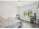 Bright bedroom has a large window and features hardwood floors and neutral decor at 3130 Bennett Creek Ln, Suwanee, GA 30024