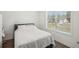 Cozy bedroom with a comfortable bed, natural light streaming in from a large window, and neutral decor at 3130 Bennett Creek Ln, Suwanee, GA 30024