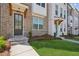 Inviting townhome front entrance featuring a wooden door and decorative wood beam details at 3130 Bennett Creek Ln, Suwanee, GA 30024