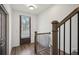 Bright entryway with wooden floors, white walls, staircase, and a view to the outdoors through the door at 3130 Bennett Creek Ln, Suwanee, GA 30024