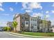 View of townhouses featuring brick and stone facade, manicured lawn, and inviting landscape design at 3130 Bennett Creek Ln, Suwanee, GA 30024