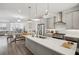 Bright, open kitchen with stainless steel appliances, island, and dining area at 3130 Bennett Creek Ln, Suwanee, GA 30024