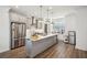 Modern kitchen with stainless steel appliances, large island, and white countertops at 3130 Bennett Creek Ln, Suwanee, GA 30024