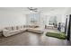 Bright living room features large sectional sofa, ceiling fan, and light wood flooring at 3130 Bennett Creek Ln, Suwanee, GA 30024