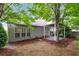 Backyard featuring a patio, privacy fence, and large shade trees at 3911 Delfaire Trce, Cumming, GA 30040