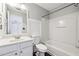 Bright bathroom featuring a shower-tub combo, modern vanity and white walls with wainscoting at 3911 Delfaire Trce, Cumming, GA 30040
