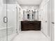Bathroom featuring double vanities, a glass shower, and marble tile flooring at 3911 Delfaire Trce, Cumming, GA 30040