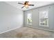 Spacious bedroom featuring neutral walls, carpet flooring, and natural light from windows at 3911 Delfaire Trce, Cumming, GA 30040