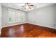 Bedroom with hardwood floors, ceiling fan, white trim and natural light at 3911 Delfaire Trce, Cumming, GA 30040