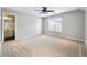 Spacious bedroom featuring neutral walls, cozy carpet, ceiling fan and a window to bring in plenty of light at 3911 Delfaire Trce, Cumming, GA 30040
