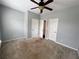 Bedroom with gray walls, ceiling fan and carpet featuring three closets/doorways at 3911 Delfaire Trce, Cumming, GA 30040