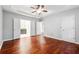 Bedroom features hardwood floors and an ensuite bath with double doors at 3911 Delfaire Trce, Cumming, GA 30040