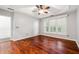 Bedroom with hardwood floors, ceiling fan, white trim and natural light at 3911 Delfaire Trce, Cumming, GA 30040