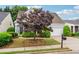 Charming one-story home boasts mature landscaping, two-car garage, and inviting curb appeal at 3911 Delfaire Trce, Cumming, GA 30040