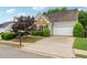 Charming one-story home boasts stone accents, two-car garage, mature landscaping, and inviting curb appeal at 3911 Delfaire Trce, Cumming, GA 30040