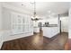 Charming dining area open to a well-equipped kitchen with white cabinetry and stainless-steel appliances at 3911 Delfaire Trce, Cumming, GA 30040