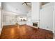 Bright open-concept living space with high ceilings, fireplace, hardwood floors and a view of the kitchen at 3911 Delfaire Trce, Cumming, GA 30040