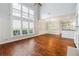 Bright living room featuring hardwood floors, a soaring window wall, and a cozy breakfast nook at 3911 Delfaire Trce, Cumming, GA 30040