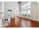 Bright living space with vaulted ceiling, tall windows, hardwood floors, fireplace, and seamless flow to entry at 3911 Delfaire Trce, Cumming, GA 30040