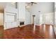 Spacious living room with fireplace, hardwood floors, and a view of the front entry at 3911 Delfaire Trce, Cumming, GA 30040