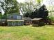 Exterior view of home featuring a large backyard and outdoor custom structure at 464 Mephisto Cir, Lawrenceville, GA 30046