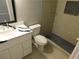 Bright bathroom with white vanity, black accents, and a tiled shower with rain head at 464 Mephisto Cir, Lawrenceville, GA 30046