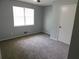 A sunlit bedroom with neutral carpet, gray walls, and a bright window creates a calm, inviting space at 464 Mephisto Cir, Lawrenceville, GA 30046