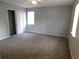 Spacious bedroom featuring two bright windows, neutral walls and plush carpeting at 464 Mephisto Cir, Lawrenceville, GA 30046