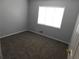 Comfortable carpeted bedroom with a window letting in natural light at 464 Mephisto Cir, Lawrenceville, GA 30046