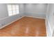 Cozy bedroom with neutral paint, laminate flooring, and natural light from the window at 464 Mephisto Cir, Lawrenceville, GA 30046