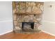 Close up of the stone fireplace with wooden mantle at 464 Mephisto Cir, Lawrenceville, GA 30046