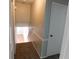 Hallway with neutral-colored walls and carpeted stairs descending to a lighter-colored floor at 464 Mephisto Cir, Lawrenceville, GA 30046