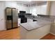 Well-lit kitchen featuring stainless steel refrigerator, granite countertops, and modern mosaic backsplash at 464 Mephisto Cir, Lawrenceville, GA 30046