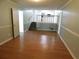 Spacious living room area with hardwood floors, steps leading to the kitchen, and bright natural light at 464 Mephisto Cir, Lawrenceville, GA 30046