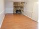 Cozy living room featuring laminate floors and a stone fireplace with a wooden mantel at 464 Mephisto Cir, Lawrenceville, GA 30046