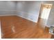 Bright living room featuring laminate flooring, white trim, and neutral walls at 464 Mephisto Cir, Lawrenceville, GA 30046