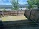 Fenced backyard with grass, trees, and a view of neighboring houses at 6905 Rogers Pt, Lithonia, GA 30058