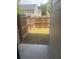 Fenced backyard with minimal grass and a concrete patio area at 6905 Rogers Pt, Lithonia, GA 30058