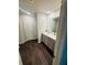 Bathroom featuring double sinks, grey cabinetry, and dark wood look flooring at 6905 Rogers Pt, Lithonia, GA 30058