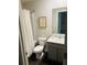 Bathroom featuring a shower with white curtain and a wood framed sign on the wall at 6905 Rogers Pt, Lithonia, GA 30058