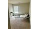 Bedroom with a large window that lets in ample natural light, and neutral carpeting at 6905 Rogers Pt, Lithonia, GA 30058