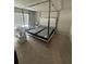 Bedroom with large window, a four-poster bed frame, and neutral carpeting at 6905 Rogers Pt, Lithonia, GA 30058