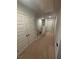 Hallway featuring neutral carpeting and multiple doors at 6905 Rogers Pt, Lithonia, GA 30058