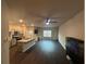 Comfortable living room and kitchen area showcasing hardwood floors and modern appliances at 6905 Rogers Pt, Lithonia, GA 30058