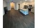 Open living room and kitchen featuring dark hardwood flooring and a granite kitchen island at 6905 Rogers Pt, Lithonia, GA 30058